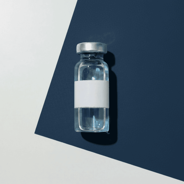 Clear glass medication vial with a metal cap